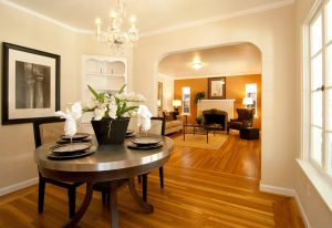 A beautifully painted dining and living area with wooden flooring, showcasing GruberPainting's craftsmanship in San Jose.